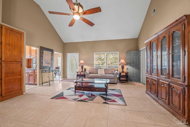 tiled living room with high vaulted ceiling and ceiling fan