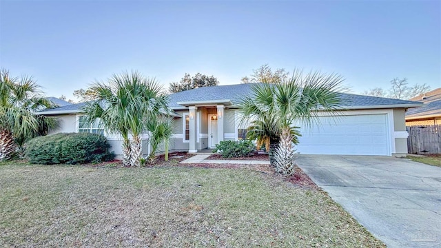 view of front of home with a garage, a front lawn, concrete driveway, and stucco siding