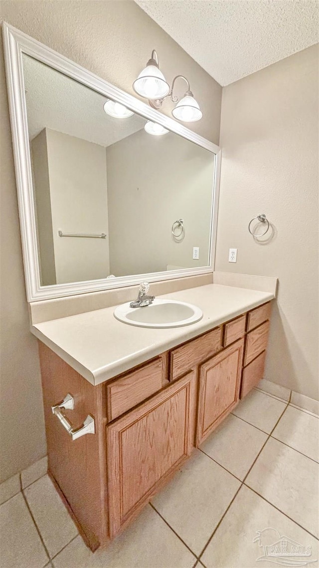 bathroom featuring a textured ceiling, tile patterned flooring, and vanity