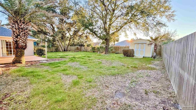 view of yard with a storage shed, an outdoor structure, and a fenced backyard