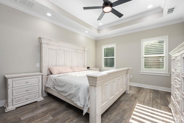 bedroom featuring crown molding, ceiling fan, dark wood-type flooring, and a raised ceiling