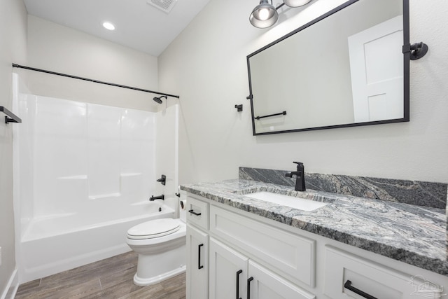 full bathroom with shower / bathing tub combination, wood-type flooring, vanity, and toilet