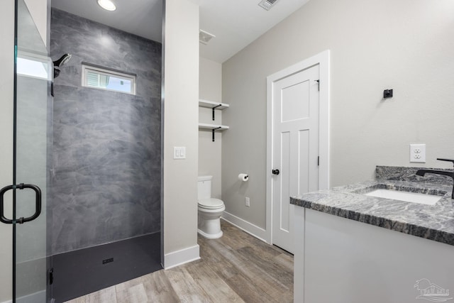 bathroom featuring vanity, hardwood / wood-style floors, toilet, and an enclosed shower