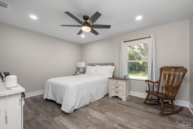 bedroom with ceiling fan and dark wood-type flooring