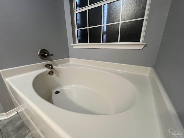 bathroom featuring a tub and tile patterned floors