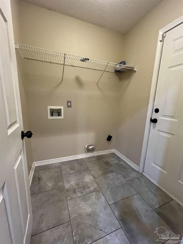 laundry area with electric dryer hookup, hookup for a washing machine, and a textured ceiling