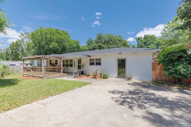 1424 Chemstrand Rd, Cantonment, FL 32533 - rear view of house featuring a pergola, a wooden deck, concrete block siding, a shingled roof, and driveway