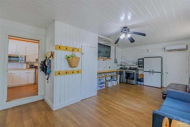 1424 Chemstrand Rd, Cantonment, FL 32533 - kitchen featuring stainless steel microwave, washer / clothes dryer, a wall mounted AC, light wood-style floors, and wood ceiling