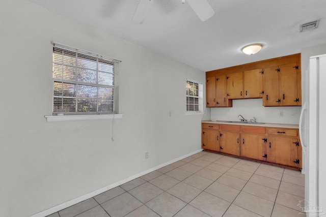 kitchen with plenty of natural light, light tile patterned flooring, and sink