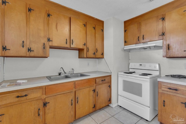 kitchen featuring electric range, sink, light tile patterned floors, and a textured ceiling