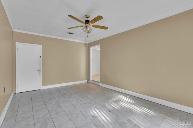 tiled empty room with ceiling fan and ornamental molding