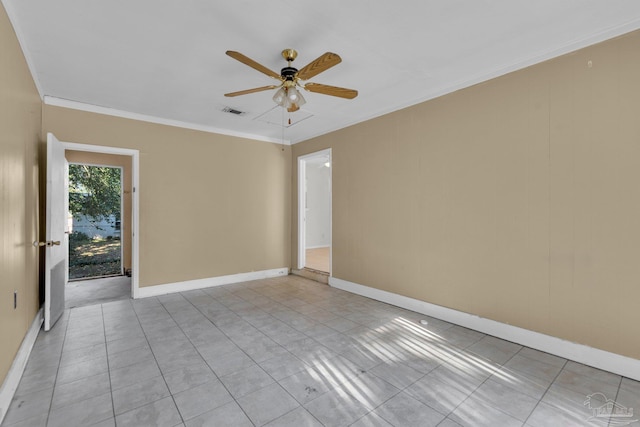 tiled spare room featuring ceiling fan and ornamental molding