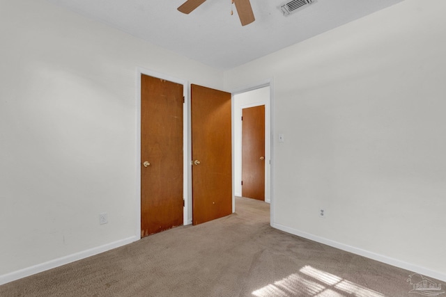 unfurnished room with light carpet and ceiling fan