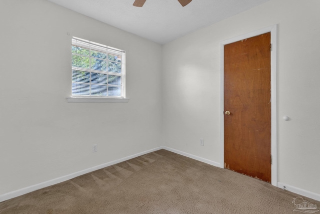 empty room featuring carpet floors and ceiling fan