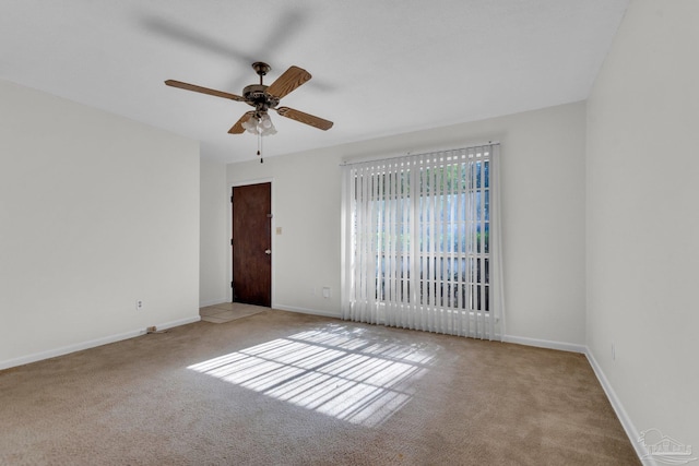 carpeted empty room featuring ceiling fan