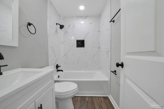 5686 Avondale Rd, Pensacola, FL 32526 - bathroom with washtub / shower combination, toilet, vanity, and wood finished floors