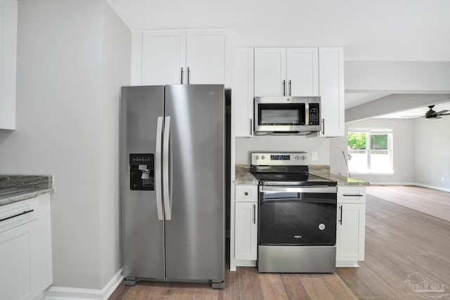 5686 Avondale Rd, Pensacola, FL 32526 - kitchen featuring ceiling fan, light stone countertops, light wood-style flooring, appliances with stainless steel finishes, and white cabinets