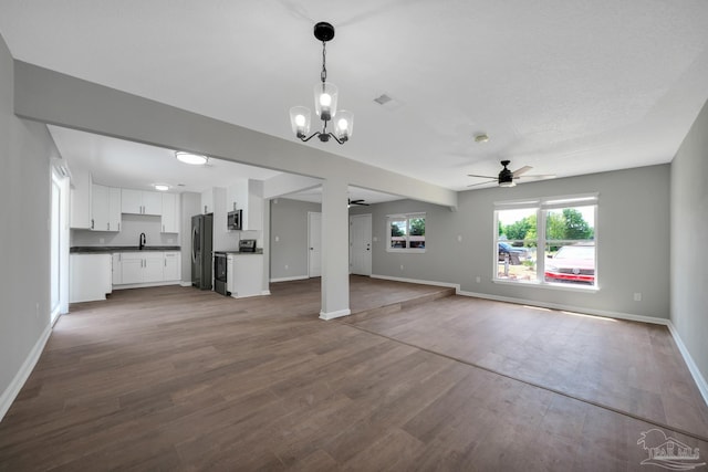 5686 Avondale Rd, Pensacola, FL 32526 - unfurnished living room featuring baseboards, visible vents, dark wood finished floors, a sink, and ceiling fan with notable chandelier