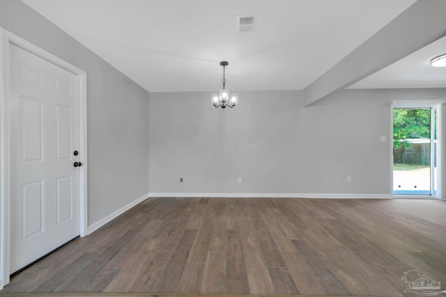 5686 Avondale Rd, Pensacola, FL 32526 - unfurnished room featuring an inviting chandelier, wood finished floors, and baseboards