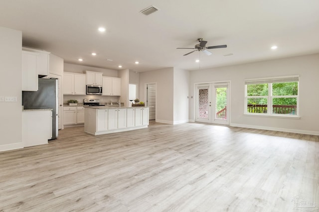 7822 Burnside Loop, Pensacola, FL 32526 - kitchen with open floor plan, appliances with stainless steel finishes, a ceiling fan, recessed lighting, and white cabinetry