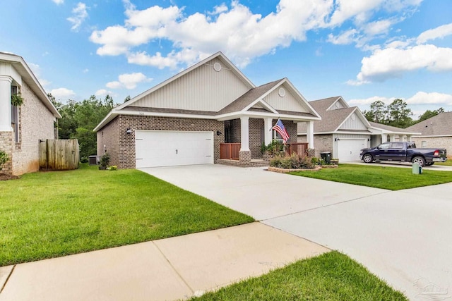 7822 Burnside Loop, Pensacola, FL 32526 - craftsman inspired home featuring an attached garage, brick siding, driveway, a front yard, and board and batten siding