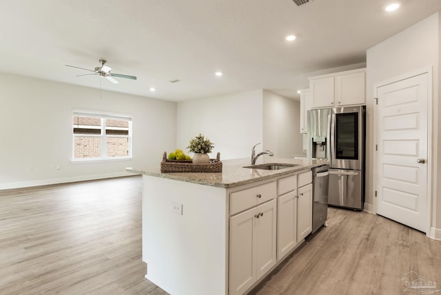7822 Burnside Loop, Pensacola, FL 32526 - kitchen with stainless steel appliances, light wood-style flooring, a ceiling fan, light stone countertops, and white cabinetry