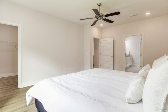 7822 Burnside Loop, Pensacola, FL 32526 - bedroom with a walk in closet, light wood-style floors, recessed lighting, ensuite bath, and a closet