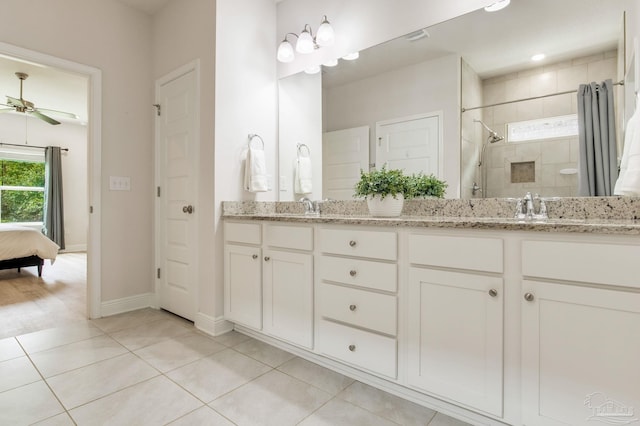 7822 Burnside Loop, Pensacola, FL 32526 - ensuite bathroom featuring double vanity, tile patterned flooring, a ceiling fan, and a tile shower