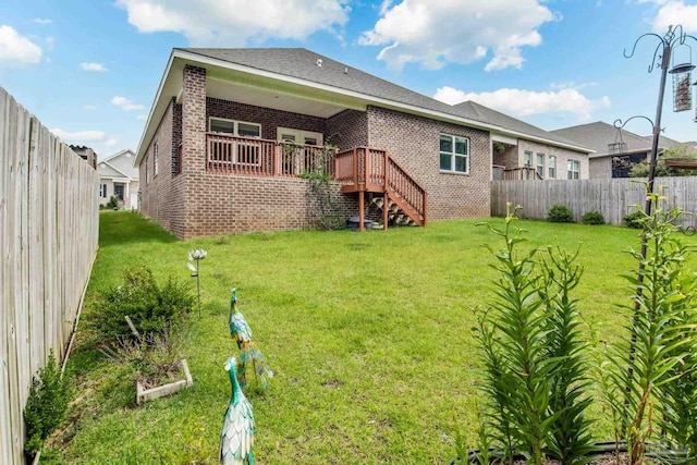 7822 Burnside Loop, Pensacola, FL 32526 - back of house featuring brick siding, a fenced backyard, stairs, and a wooden deck