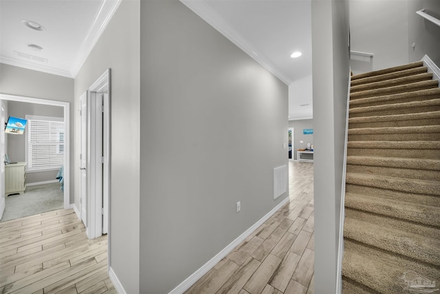 stairway with hardwood / wood-style flooring, ornamental molding, and radiator heating unit