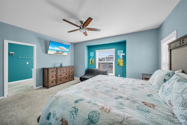 bedroom with ceiling fan and light colored carpet