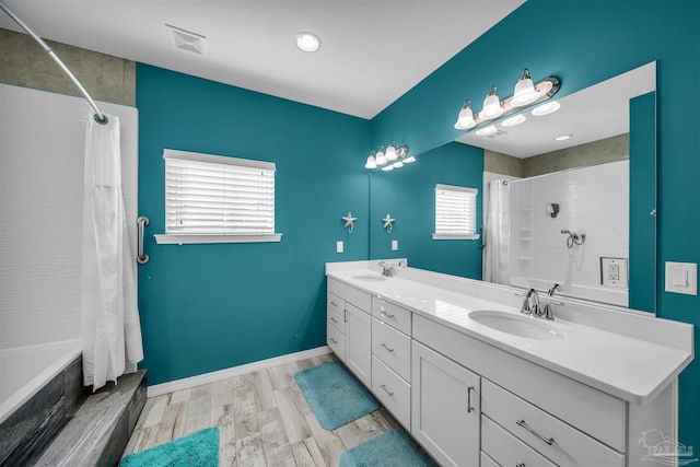 bathroom featuring hardwood / wood-style flooring, vanity, a healthy amount of sunlight, and shower / bathtub combination with curtain