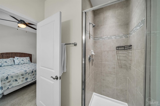 bathroom with ceiling fan and a shower with door