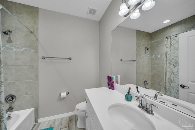 full bathroom featuring vanity, wood-type flooring, shower / bath combo, and toilet