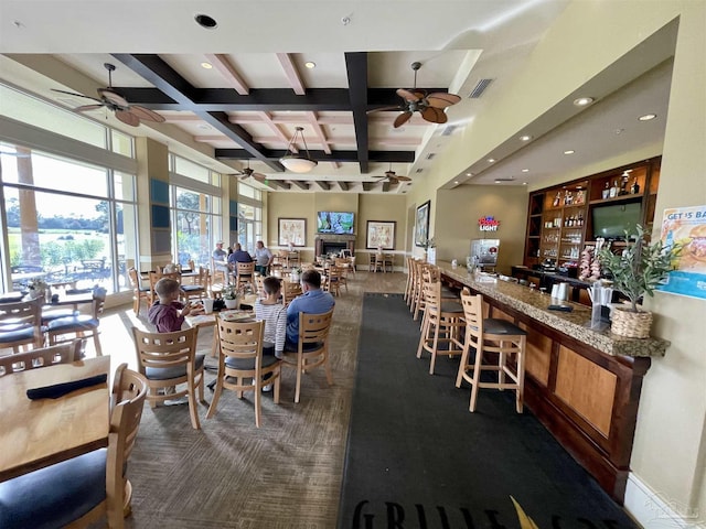 dining space with beamed ceiling and coffered ceiling