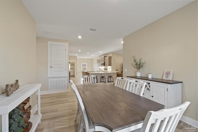 dining area with light hardwood / wood-style flooring