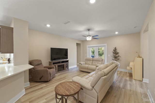 living room with ceiling fan, light wood-type flooring, and french doors