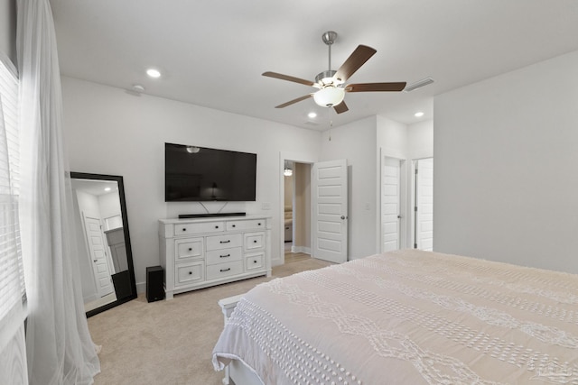 bedroom with multiple windows, ceiling fan, and light colored carpet