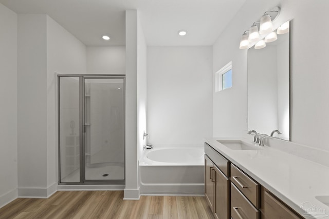 bathroom with vanity, separate shower and tub, and wood-type flooring