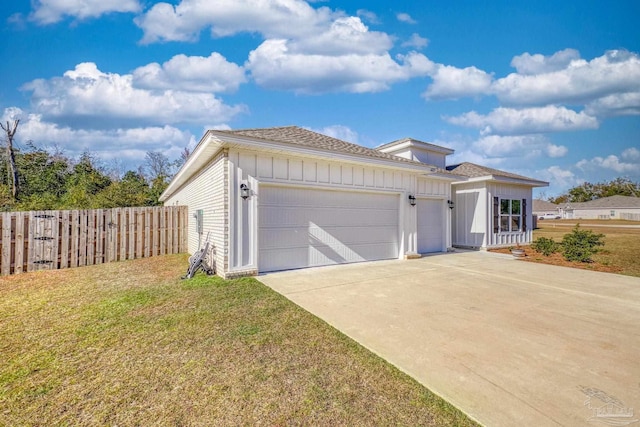 view of front of property with a garage and a front lawn