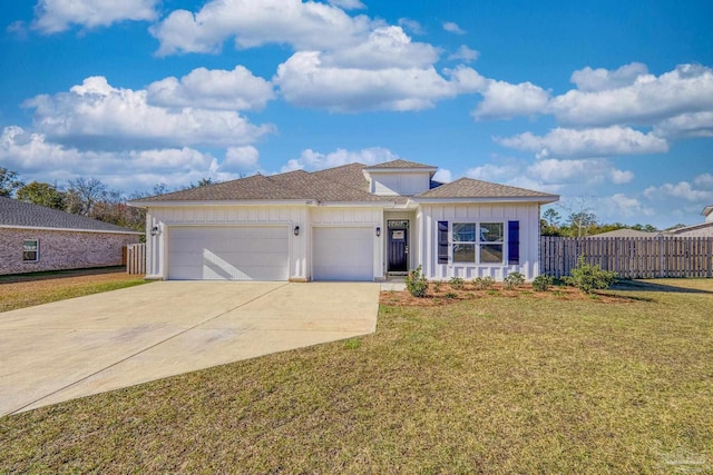 view of front of home with a front yard and a garage