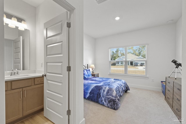 carpeted bedroom featuring sink