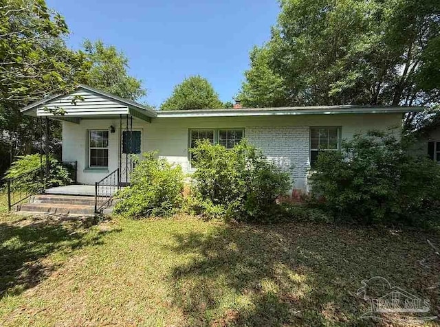 602 Coulter Ave, Cantonment, FL 32533 - back of house featuring a lawn