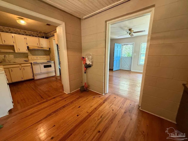 602 Coulter Ave, Cantonment, FL 32533 - kitchen featuring range with two ovens, under cabinet range hood, hardwood / wood-style flooring, a sink, and light countertops