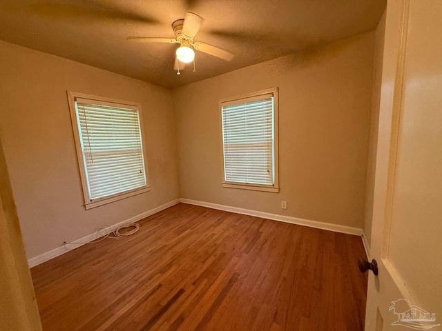 602 Coulter Ave, Cantonment, FL 32533 - unfurnished room featuring plenty of natural light, dark wood-style flooring, a ceiling fan, and baseboards