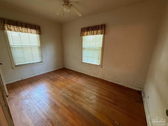 602 Coulter Ave, Cantonment, FL 32533 - empty room with healthy amount of natural light, wood finished floors, ceiling fan, and baseboards
