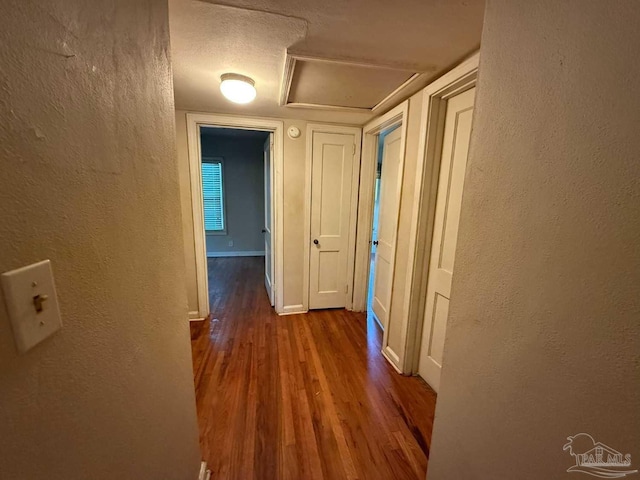 602 Coulter Ave, Cantonment, FL 32533 - corridor with wood finished floors, a textured wall, attic access, and baseboards