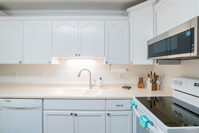 kitchen featuring white cabinets, white appliances, and sink