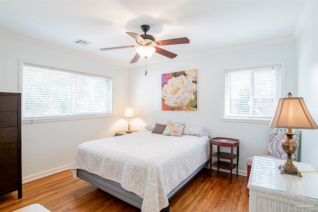 bedroom with ceiling fan, wood-type flooring, and crown molding