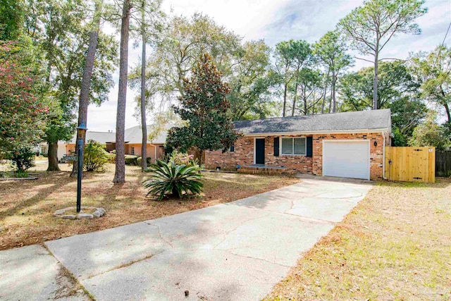 ranch-style home with a front lawn and a garage